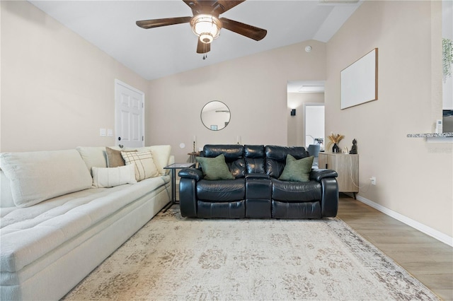 living room featuring ceiling fan, wood finished floors, baseboards, and lofted ceiling