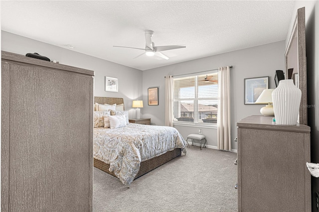 bedroom with light carpet, ceiling fan, and a textured ceiling