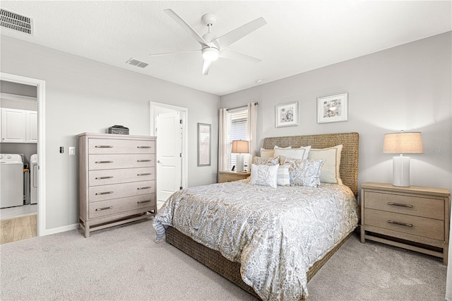 carpeted bedroom featuring washer and dryer and ceiling fan