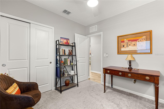 interior space with light carpet and ceiling fan