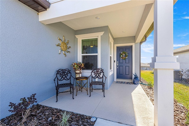 view of exterior entry with central AC unit