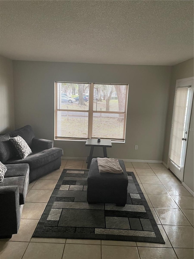 living room with light tile patterned floors and a textured ceiling