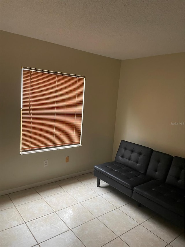 interior space featuring a textured ceiling and light tile patterned flooring