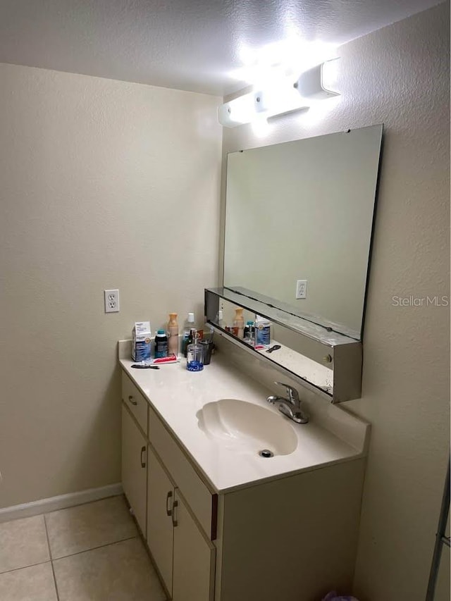 bathroom with tile patterned floors and vanity