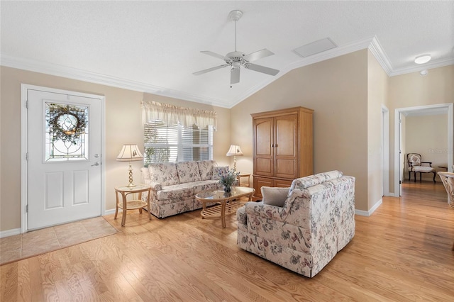 living room featuring crown molding, ceiling fan, lofted ceiling, and light wood-type flooring