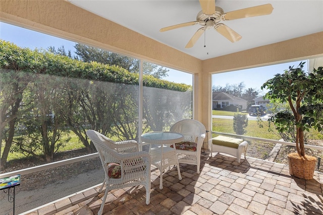 sunroom featuring ceiling fan