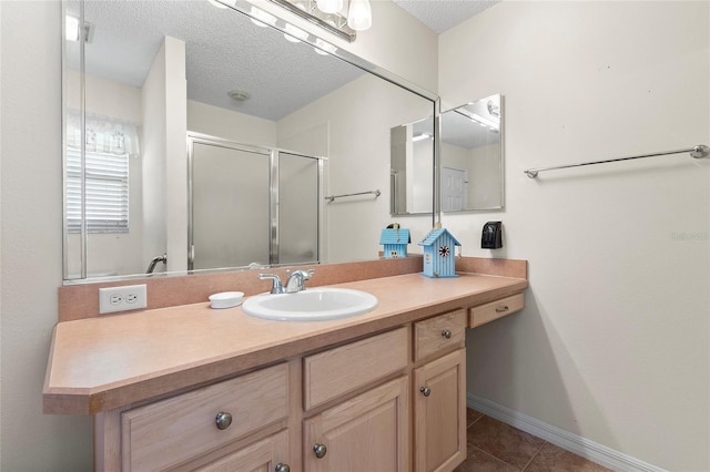 bathroom with vanity, tile patterned floors, a textured ceiling, and walk in shower