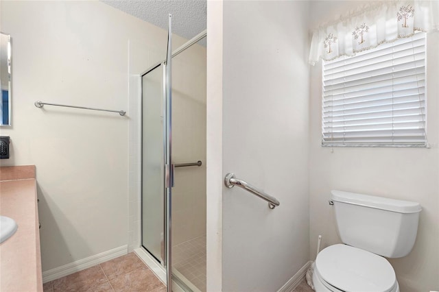 bathroom with walk in shower, tile patterned floors, toilet, a textured ceiling, and vanity