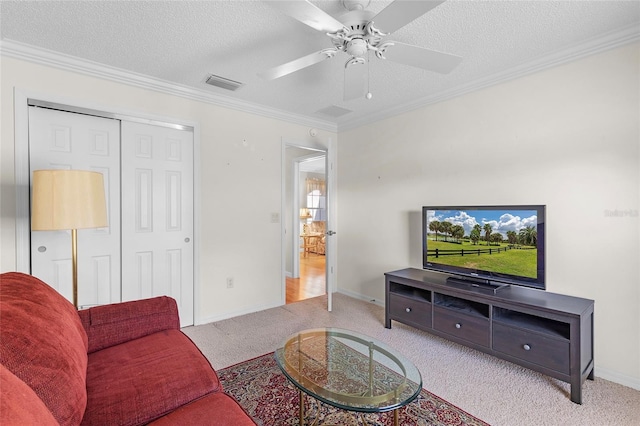 carpeted living room with ceiling fan, ornamental molding, and a textured ceiling