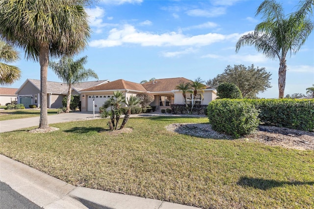 single story home featuring a garage and a front lawn