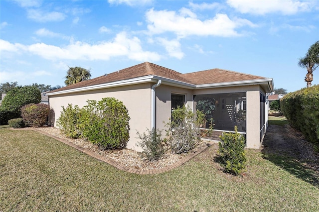 view of property exterior with a sunroom and a lawn