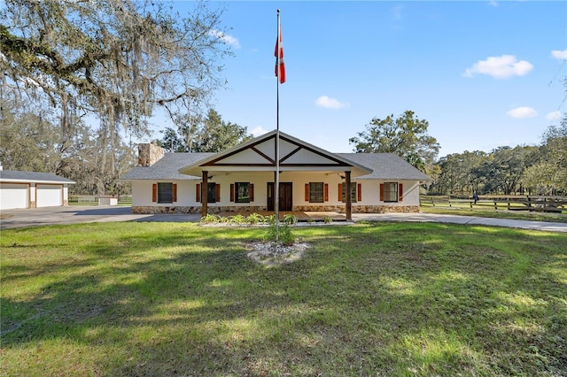 view of front of property with a front yard and a garage