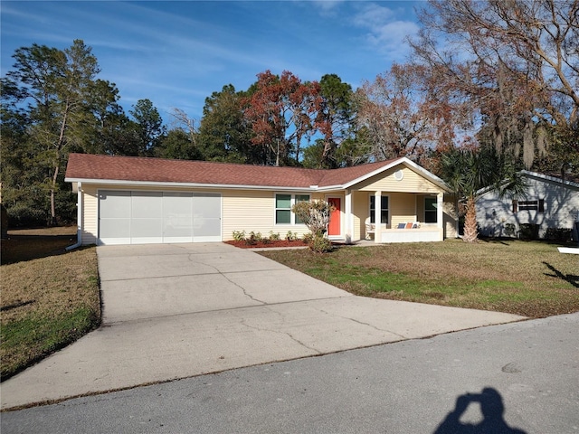 ranch-style house with a front yard, a garage, and a porch