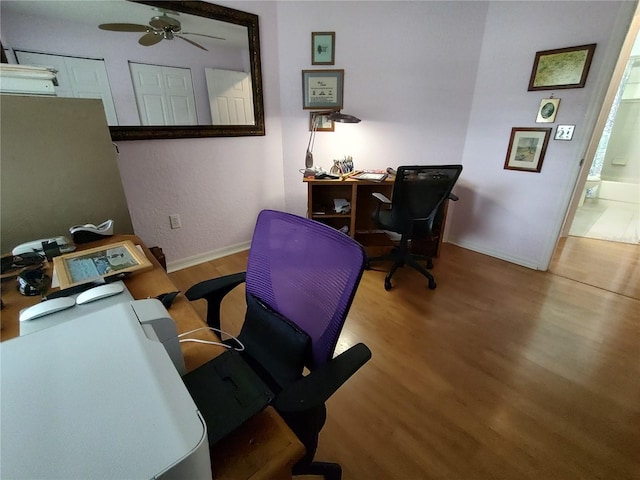 home office featuring ceiling fan and hardwood / wood-style flooring