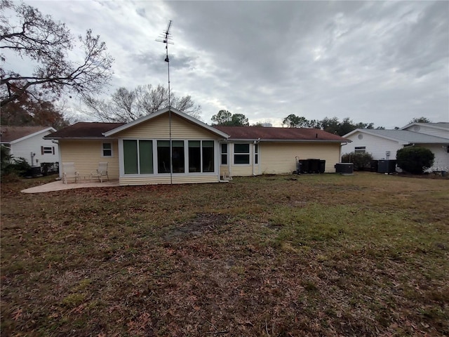 rear view of property with a yard and a patio