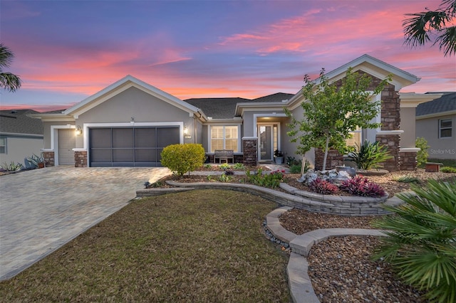 view of front of property featuring a yard and a garage