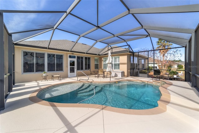 view of swimming pool featuring glass enclosure and a patio area