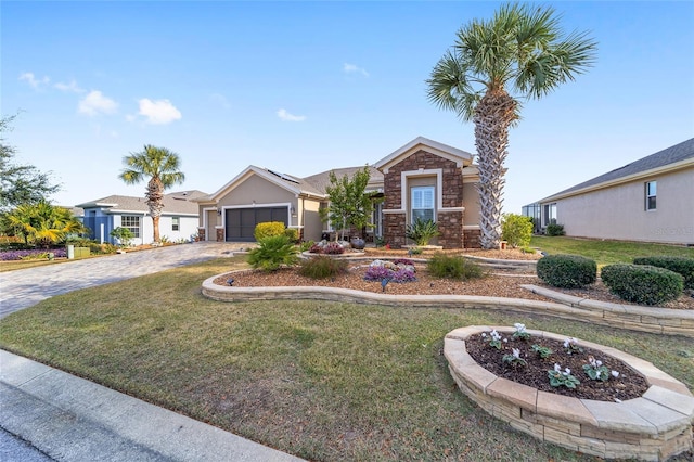 single story home featuring a front lawn and a garage