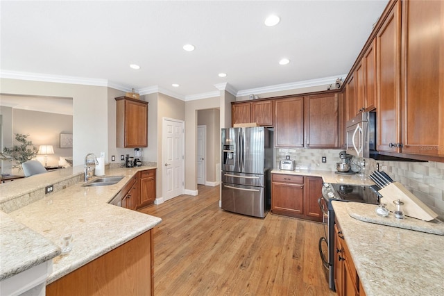 kitchen with tasteful backsplash, sink, stainless steel appliances, and ornamental molding