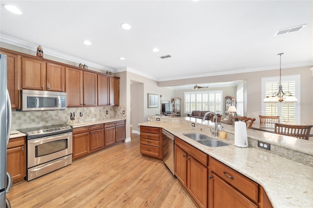 kitchen with ceiling fan with notable chandelier, sink, appliances with stainless steel finishes, and crown molding