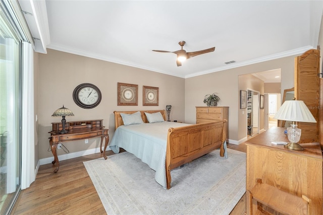 bedroom featuring ceiling fan, light hardwood / wood-style flooring, and ornamental molding