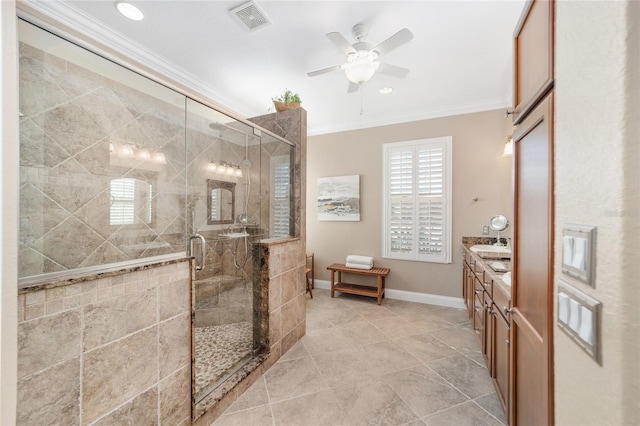 bathroom featuring ceiling fan, ornamental molding, a shower with shower door, and vanity