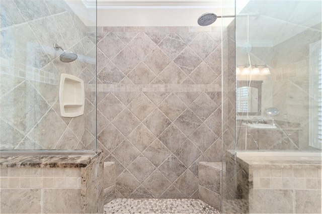 bathroom featuring crown molding and tiled shower