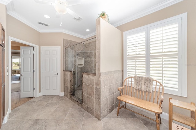 bathroom featuring ceiling fan, ornamental molding, tile patterned flooring, and an enclosed shower