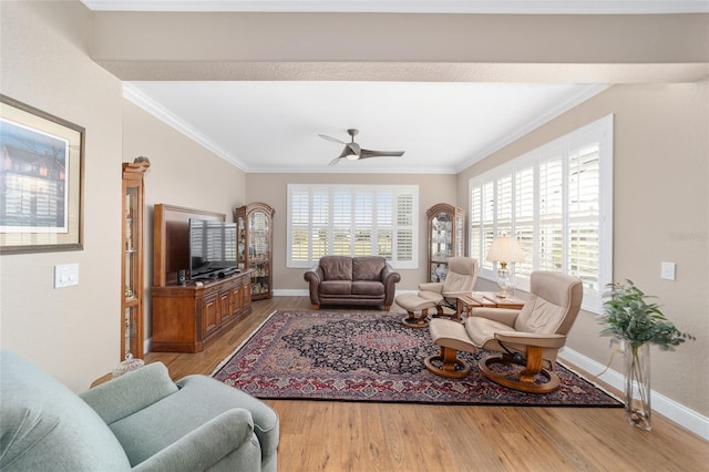 living room with ceiling fan, ornamental molding, and light hardwood / wood-style floors