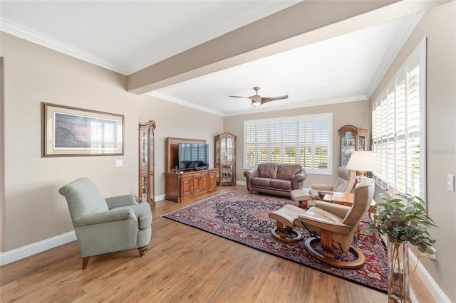 living room with ceiling fan, crown molding, and light hardwood / wood-style flooring