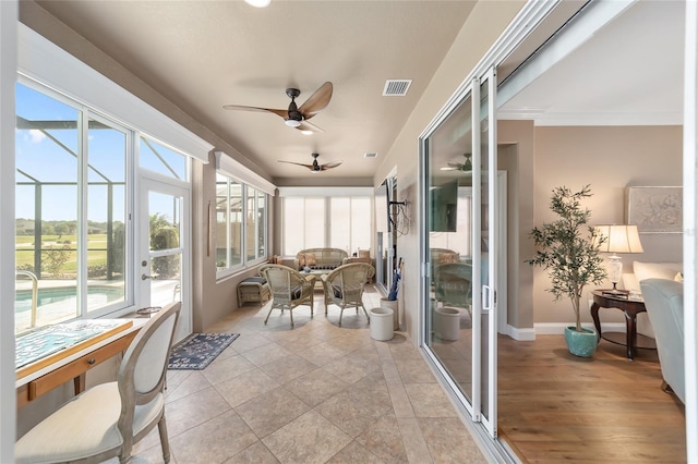 sunroom featuring ceiling fan