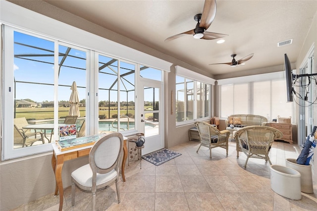 sunroom featuring ceiling fan