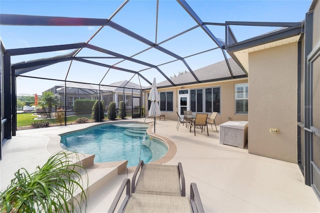 view of swimming pool featuring glass enclosure and a patio