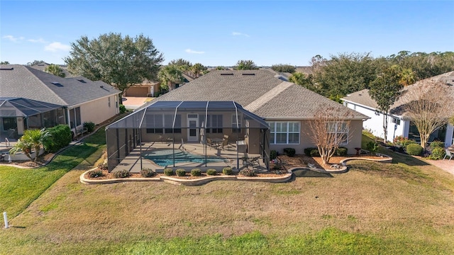 back of house featuring glass enclosure, a lawn, and a patio