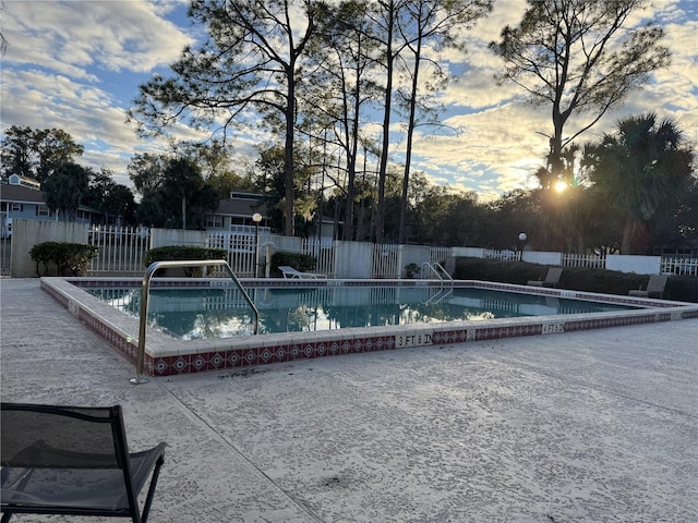 pool at dusk with a patio