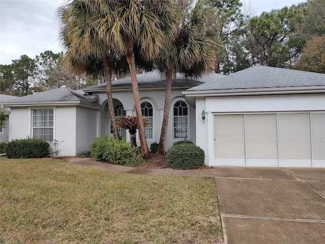 view of front of home featuring a garage and a front yard