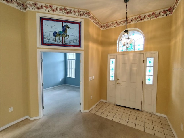 carpeted foyer with a healthy amount of sunlight