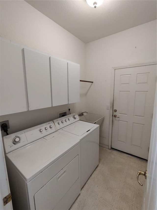 laundry room with washer and dryer, sink, and cabinets