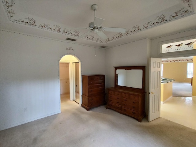 unfurnished bedroom featuring ceiling fan and light colored carpet