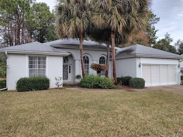 view of front facade featuring a garage and a front lawn