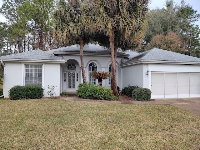 view of front facade featuring a garage and a front lawn