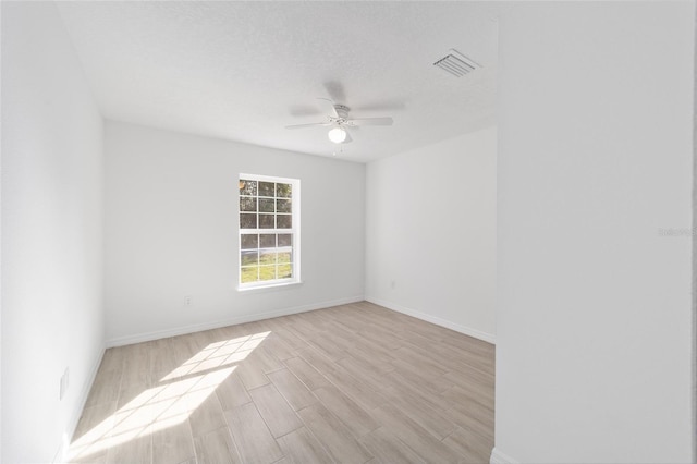 spare room featuring light wood-type flooring and ceiling fan