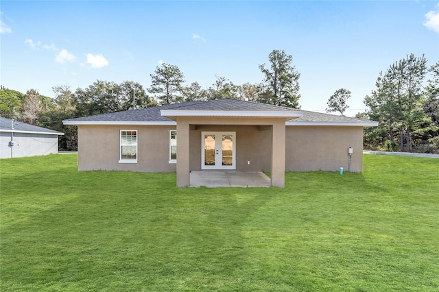 back of house with a yard, a patio area, and french doors