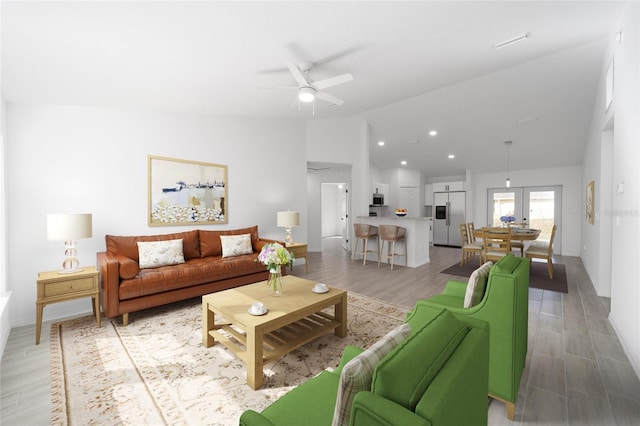 living room with hardwood / wood-style flooring, ceiling fan, and lofted ceiling