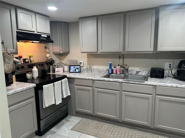 kitchen with black range with electric cooktop, light tile patterned flooring, sink, and gray cabinets