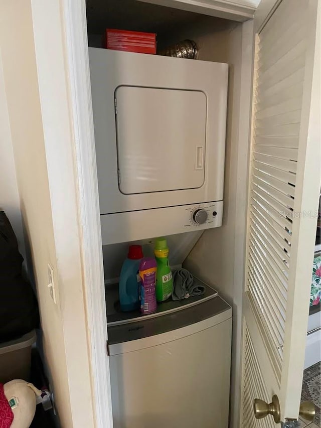 laundry area featuring stacked washer and clothes dryer