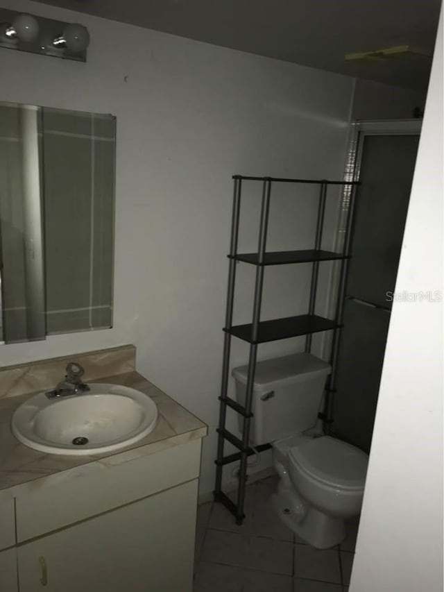 bathroom with tile patterned floors, vanity, and toilet