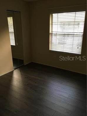 spare room featuring dark hardwood / wood-style flooring