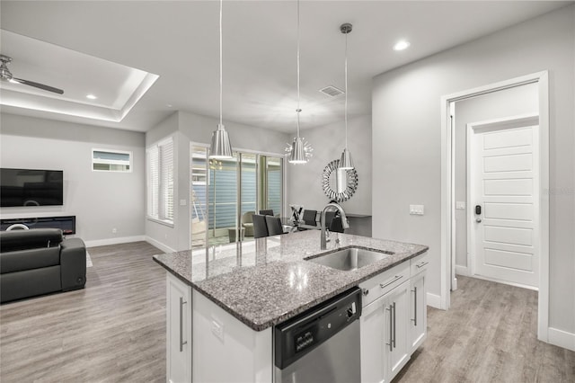 kitchen featuring ceiling fan with notable chandelier, pendant lighting, dishwasher, white cabinetry, and sink