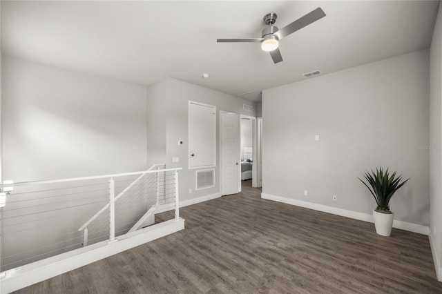 empty room featuring ceiling fan and dark hardwood / wood-style floors